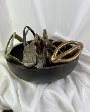 A Unique Collection of 7 mid-1800’s Antique Equestrian Stirrups sold in an Antique Wooden bread Bowl